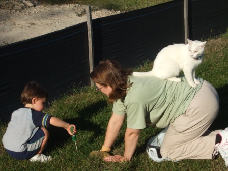 Sylvia watching Alex weeding